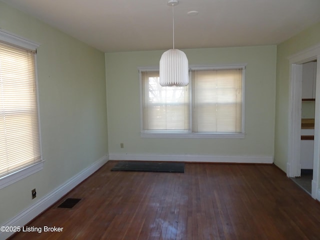 unfurnished dining area featuring dark hardwood / wood-style flooring