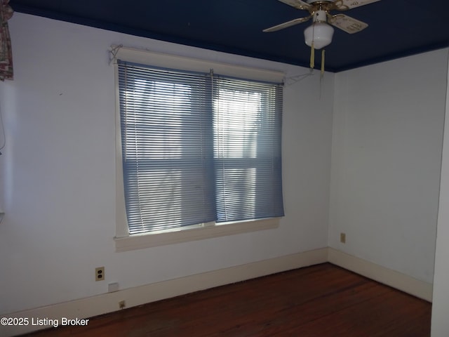 empty room with dark wood-type flooring and ceiling fan