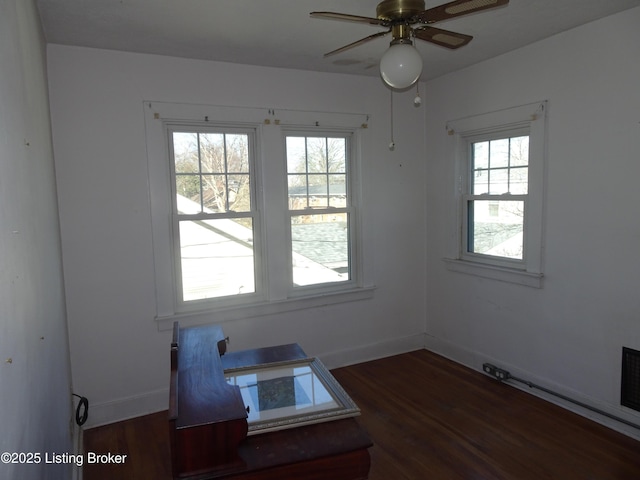 unfurnished dining area with dark hardwood / wood-style flooring, plenty of natural light, and ceiling fan