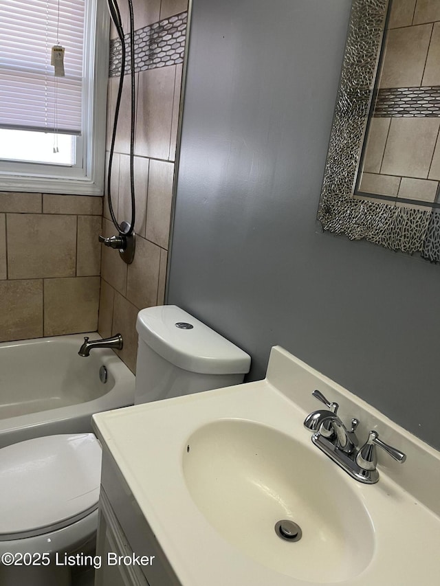 full bathroom with vanity, toilet, and tiled shower / bath combo