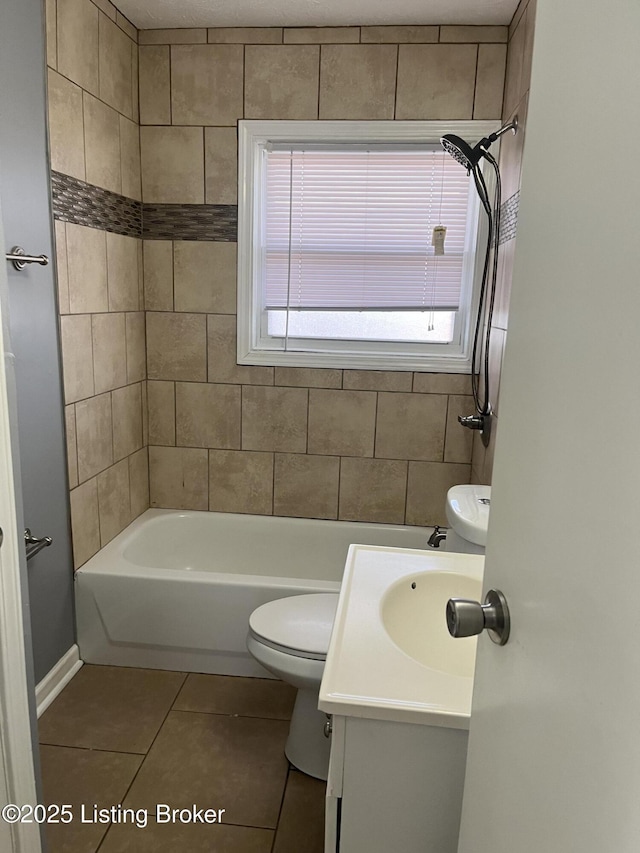 full bathroom with vanity, tiled shower / bath, tile patterned floors, and toilet