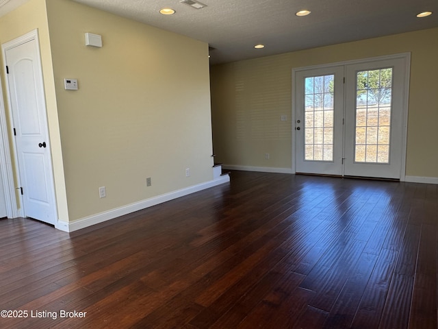 unfurnished room with dark hardwood / wood-style flooring