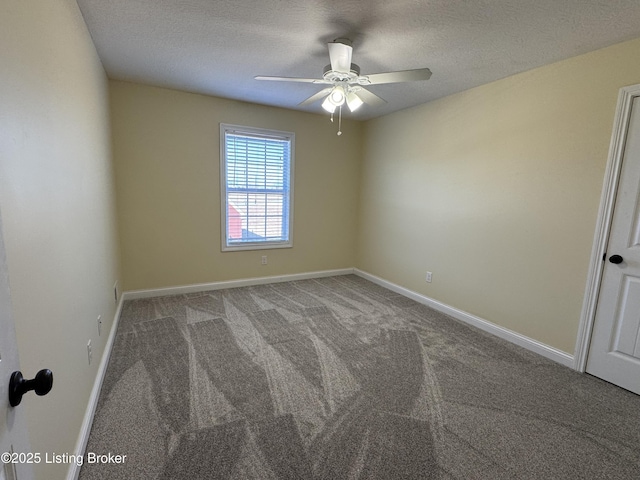 carpeted spare room featuring ceiling fan and a textured ceiling