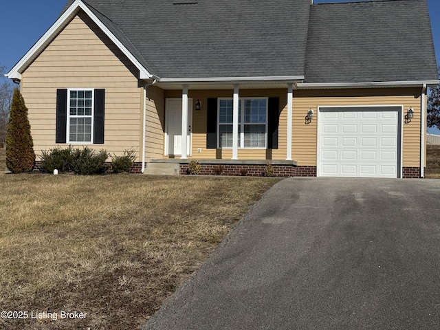 view of front of home with a garage, covered porch, and a front yard