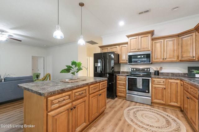 kitchen featuring crown molding, decorative light fixtures, a kitchen island, stainless steel appliances, and light hardwood / wood-style floors