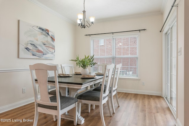 dining room featuring crown molding, a healthy amount of sunlight, and light hardwood / wood-style flooring