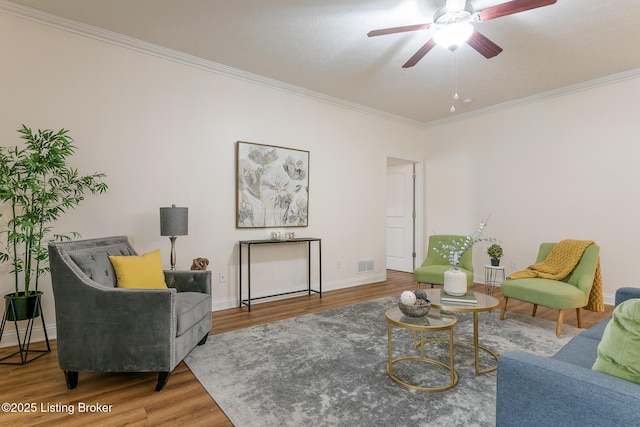 living room with crown molding, hardwood / wood-style flooring, and ceiling fan