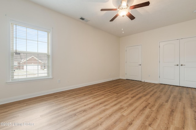 unfurnished bedroom featuring light hardwood / wood-style flooring, a closet, and ceiling fan