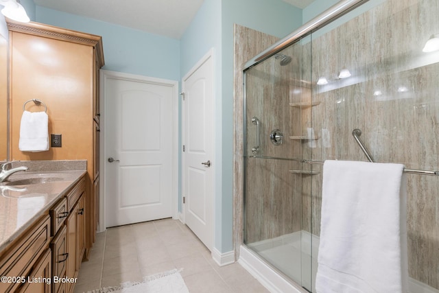 bathroom with tile patterned flooring, vanity, and a shower with shower door