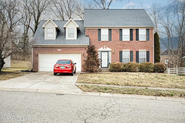 view of front of property featuring a garage and a front lawn