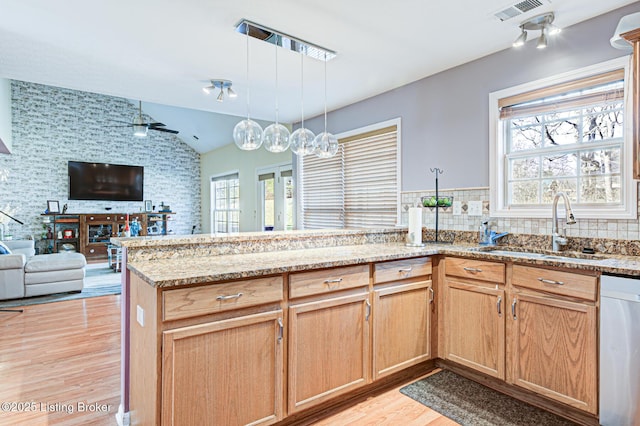 kitchen with pendant lighting, stainless steel dishwasher, plenty of natural light, and sink