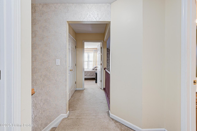 hallway with light colored carpet