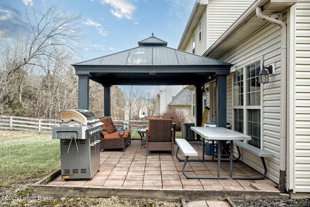 view of patio featuring a gazebo, area for grilling, and an outdoor living space