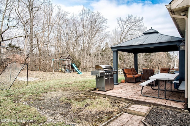 view of yard featuring a gazebo, a playground, and a patio