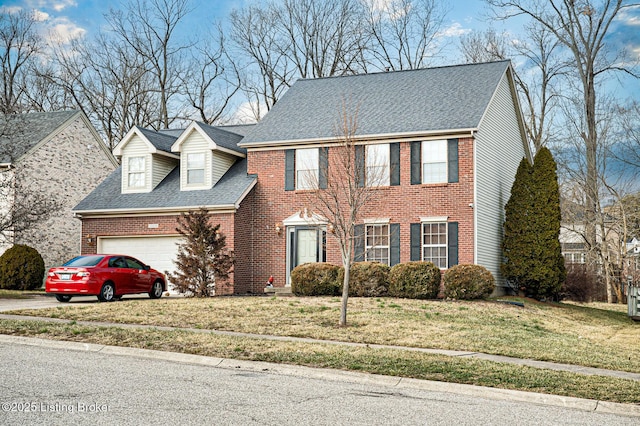 view of front of property with a garage and a front lawn