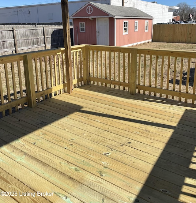 wooden terrace with a storage shed