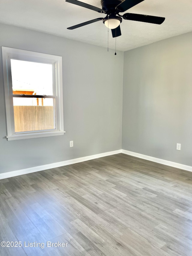 spare room featuring hardwood / wood-style flooring and ceiling fan