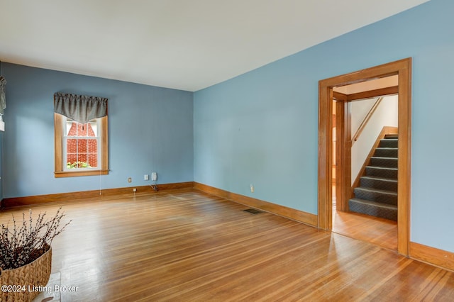 unfurnished room with hardwood / wood-style flooring