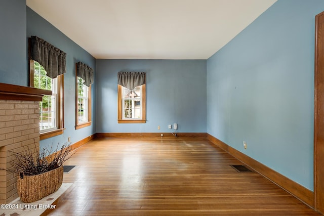 empty room with hardwood / wood-style flooring