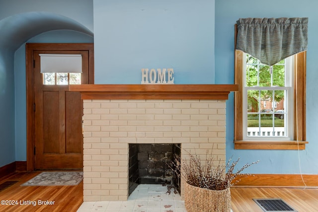 details with hardwood / wood-style flooring and a fireplace