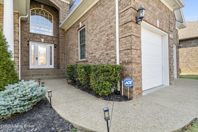 view of exterior entry with a garage