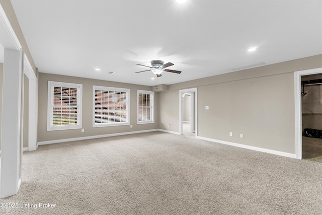 carpeted empty room featuring ceiling fan