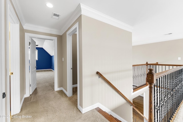 hall with crown molding and light colored carpet