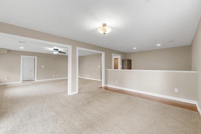 basement with light carpet and ceiling fan