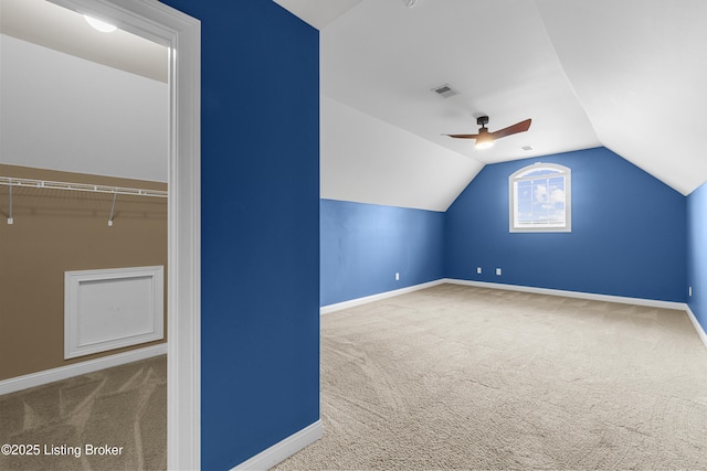 bonus room featuring lofted ceiling, carpet floors, and ceiling fan