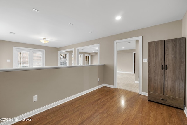 spare room with hardwood / wood-style flooring