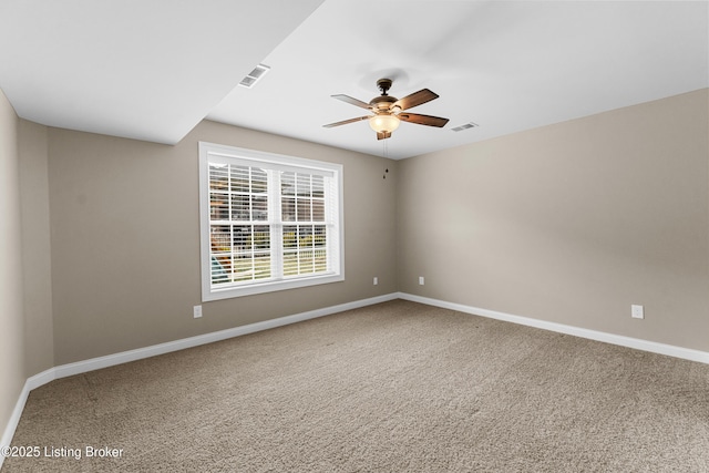 carpeted spare room with ceiling fan