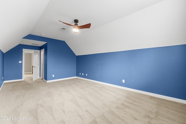 bonus room with vaulted ceiling, light carpet, and ceiling fan