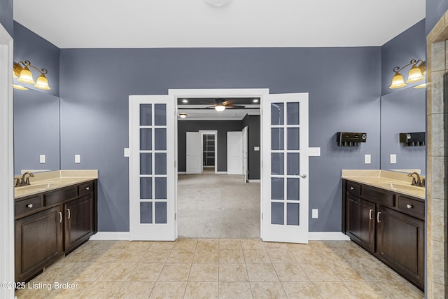 bathroom with tile patterned flooring, vanity, french doors, and ceiling fan