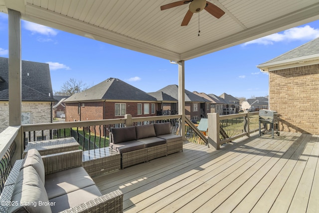 deck with an outdoor living space, a grill, and ceiling fan