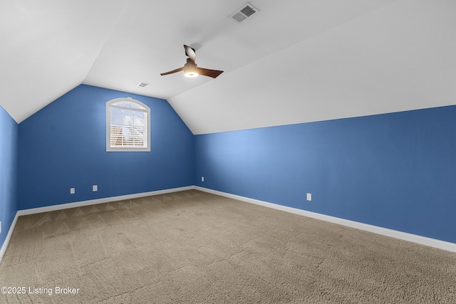 bonus room featuring lofted ceiling, ceiling fan, and carpet