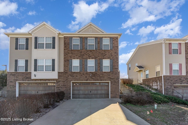 multi unit property featuring concrete driveway, brick siding, and an attached garage