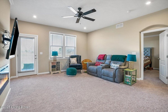 living room with light carpet and ceiling fan