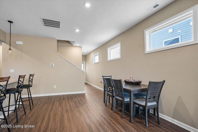 dining space with dark hardwood / wood-style floors