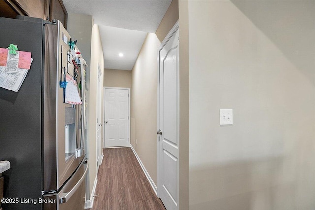 hallway with hardwood / wood-style flooring