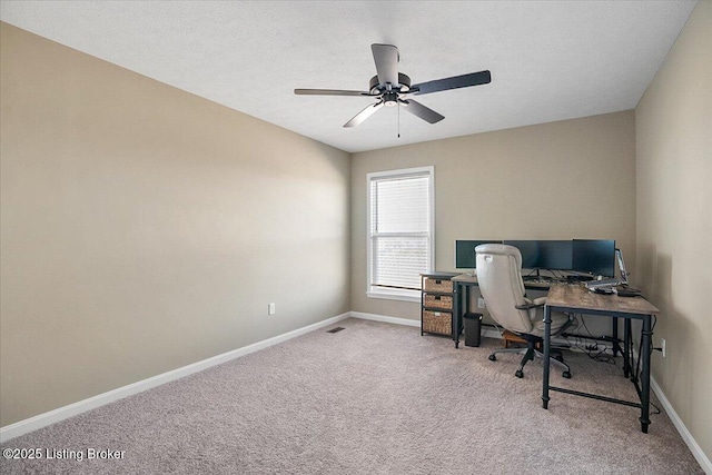 office space with carpet, a textured ceiling, and ceiling fan