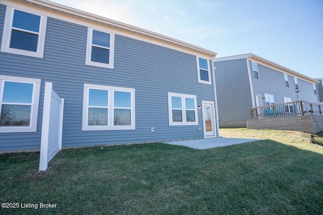 back of property featuring a yard and a patio area