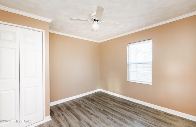 unfurnished bedroom with wood-type flooring, ceiling fan, crown molding, and a closet