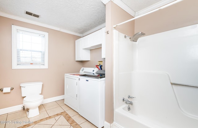 full bathroom featuring washing machine and clothes dryer, toilet,  shower combination, a textured ceiling, and tile patterned flooring