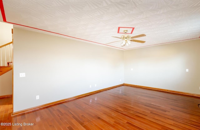 spare room with ceiling fan, a textured ceiling, and light wood-type flooring