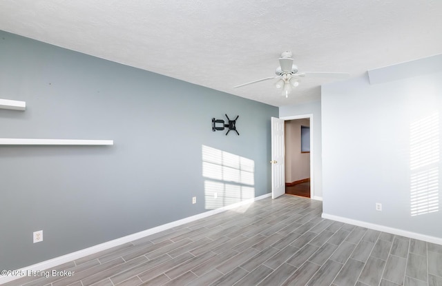 empty room featuring a textured ceiling and ceiling fan