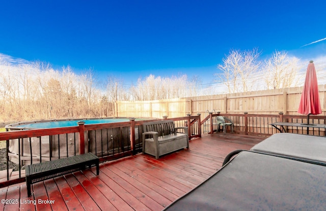 wooden terrace with a fenced in pool