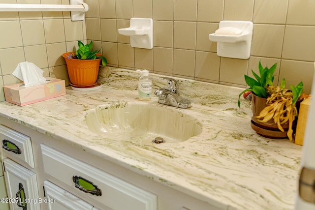 bathroom with vanity and backsplash