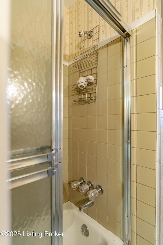 bathroom with shower / bath combination with glass door