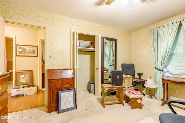 interior space with ceiling fan and light carpet