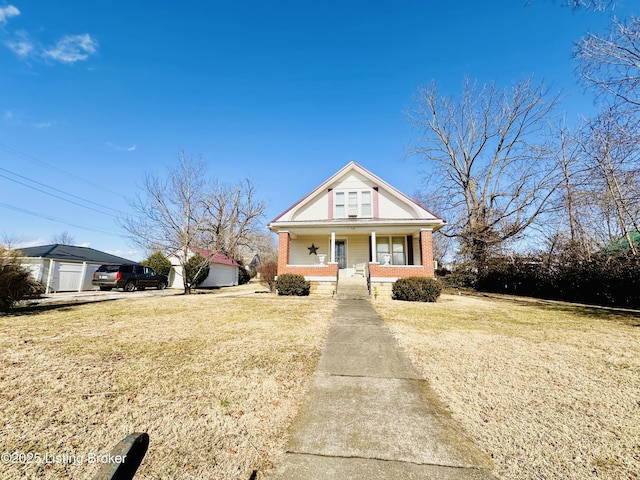 view of front facade with a front yard and covered porch